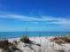 Scenic beach view with calm ocean and sea oats at 5 Pointe Way, Placida, FL 33946