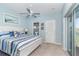 Main bedroom with a white bed, blue walls, and access to a balcony at 5 Pointe Way, Placida, FL 33946