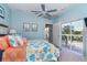 Bedroom with coral bedding, ceiling fan, and access to a deck at 5 Pointe Way, Placida, FL 33946