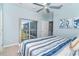 Bedroom with a blue and white striped comforter and sliding glass doors at 5 Pointe Way, Placida, FL 33946