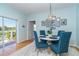 Small breakfast nook with a round table and blue chairs, near a back door at 5 Pointe Way, Placida, FL 33946