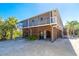 Two-story home with screened porch and wooden accents at 5 Pointe Way, Placida, FL 33946