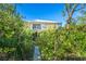 Back exterior showing elevated home with boardwalk path at 5 Pointe Way, Placida, FL 33946