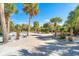 Landscaped entry to waterfront home with palm trees and shell driveway at 5 Pointe Way, Placida, FL 33946