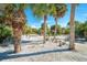 Mature palm trees and a shell driveway enhance curb appeal at 5 Pointe Way, Placida, FL 33946