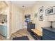 Hallway with light wood flooring, blue dresser, and access to bedroom at 5 Pointe Way, Placida, FL 33946