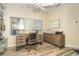 Home office with built-in wooden desk and shelving at 5 Pointe Way, Placida, FL 33946