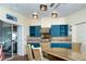 View of outdoor kitchen with blue cabinets and a stainless steel grill at 5 Pointe Way, Placida, FL 33946