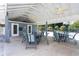 Relaxing poolside patio furniture under covered cabana at 5 Pointe Way, Placida, FL 33946