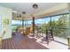 Relaxing screened porch with wicker furniture, offering water views at 5 Pointe Way, Placida, FL 33946