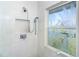 Clean shower with tiled walls, handheld showerhead, and a window at 5 Pointe Way, Placida, FL 33946