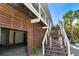 Wooden stairs leading to elevated home with wooden siding at 5 Pointe Way, Placida, FL 33946