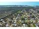 Aerial view of neighborhood homes near green spaces and the ocean at 5031 Lucine Rd, Venice, FL 34293