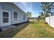 Fenced backyard featuring a well-maintained lawn, offering a private space perfect for outdoor activities and entertaining at 5031 Lucine Rd, Venice, FL 34293