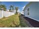 Backyard featuring a white fence line and blue vinyl siding at 5031 Lucine Rd, Venice, FL 34293