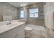 Bathroom featuring tiled walls and flooring, tub/shower combo and glass shelving at 5031 Lucine Rd, Venice, FL 34293