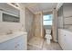 Bathroom featuring a step in shower, single sink vanity and adjacent washer and dryer at 5031 Lucine Rd, Venice, FL 34293