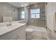 Bathroom featuring tiled walls and flooring, tub/shower combo and glass shelving at 5031 Lucine Rd, Venice, FL 34293