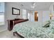 Comfortable bedroom featuring light tile flooring, a ceiling fan, and a queen-size bed with decorative green pattern comforter at 5031 Lucine Rd, Venice, FL 34293