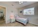 Cozy bedroom featuring light tile flooring, a window, and a twin bed with decorative comforter at 5031 Lucine Rd, Venice, FL 34293