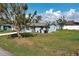 Exterior view of home with lush landscaping and a well-maintained lawn for a peaceful and inviting atmosphere at 5031 Lucine Rd, Venice, FL 34293