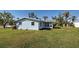 Well-maintained home featuring a screened-in porch and a lush lawn, creating a serene and inviting outdoor space at 5031 Lucine Rd, Venice, FL 34293