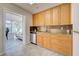 Well-equipped kitchen featuring modern appliances, cabinets, and a sink; overlooks a sun room beyond at 5031 Lucine Rd, Venice, FL 34293