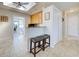 Bright kitchen with tan floors, a skylight, updated cabinets, and a small bar with barstools overlooking the Gathering room at 5031 Lucine Rd, Venice, FL 34293