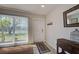 Bright living room with a large window, tile floors, and a front door at 5031 Lucine Rd, Venice, FL 34293