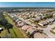 Aerial view of a residential neighborhood with tree-lined streets, landscaped lawns, and beautiful home exteriors at 525 Foxwood Blvd, Englewood, FL 34223