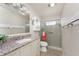 Well-lit bathroom featuring a granite vanity and glass-enclosed shower at 525 Foxwood Blvd, Englewood, FL 34223