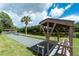 Bocce ball court by a pond with covered seating, perfect for outdoor recreation and relaxation at 525 Foxwood Blvd, Englewood, FL 34223