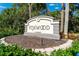 Community sign for Foxwood, a 55+ community, surrounded by lush landscaping and mature trees at 525 Foxwood Blvd, Englewood, FL 34223