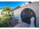 Inviting entryway with decorative lions, a secure gate, and lush landscaping leading to the front door at 525 Foxwood Blvd, Englewood, FL 34223