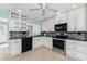 A modern kitchen featuring white cabinets, stainless steel appliances, and stylish backsplash at 525 Foxwood Blvd, Englewood, FL 34223