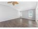 Bright living room features wood floors, large windows with plantation shutters, and neutral paint at 525 Foxwood Blvd, Englewood, FL 34223