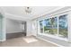 Sunlit living room with large windows and a view of the landscaped backyard at 525 Foxwood Blvd, Englewood, FL 34223