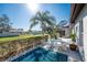 A private backyard patio featuring a dining set, lush greenery, and serene outdoor space at 525 Foxwood Blvd, Englewood, FL 34223