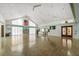 Spacious recreation room featuring a fireplace, high ceilings, and large windows that provides abundant light at 525 Foxwood Blvd, Englewood, FL 34223