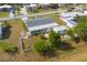 An aerial view highlights the screened in patio with a white picket fence and mature trees at 5280 Grobe St, North Port, FL 34287