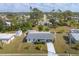 An aerial view of a charming single-story home with a well-maintained lawn and a driveway at 5280 Grobe St, North Port, FL 34287