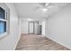 Clean bedroom featuring white walls, wood-look flooring, and a ceiling fan at 5280 Grobe St, North Port, FL 34287