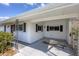 A well-maintained carport with a concrete floor, and brown window shutters at 5280 Grobe St, North Port, FL 34287