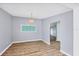 Bright dining room with wood-look flooring and modern light fixture at 5280 Grobe St, North Port, FL 34287