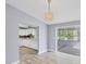 Open concept dining room with wood-look flooring leads to kitchen and sunroom at 5280 Grobe St, North Port, FL 34287