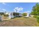 Exterior view of a home featuring a sunroom and spacious outdoor areas at 5280 Grobe St, North Port, FL 34287