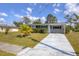 A charming single-story home with a well-maintained lawn and a concrete driveway at 5280 Grobe St, North Port, FL 34287