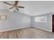 A living room featuring laminate floors, natural light, and a ceiling fan at 5280 Grobe St, North Port, FL 34287