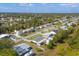 This aerial view shows the home in the neighborhood with well-manicured lawns at 5280 Grobe St, North Port, FL 34287