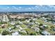 Expansive aerial view of a residential community, showcasing single-Gathering homes and lush greenery under a partly cloudy sky at 621 Tarpon Way, Punta Gorda, FL 33950